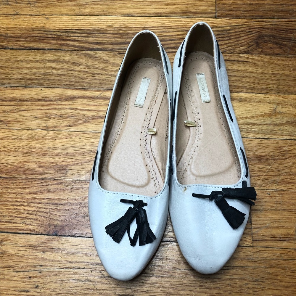 White loafer style flats with tassels